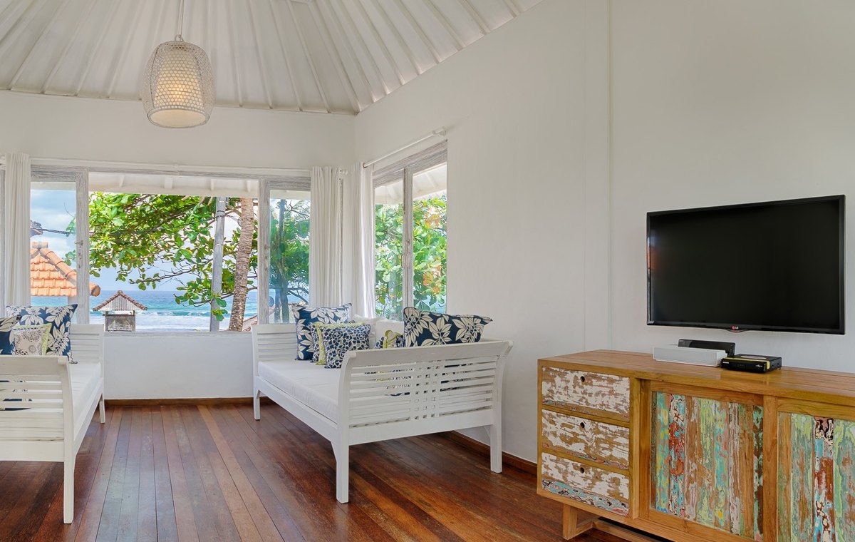 Bright upstairs living room at Pantai Indah Beach House with tropical light and ocean air.